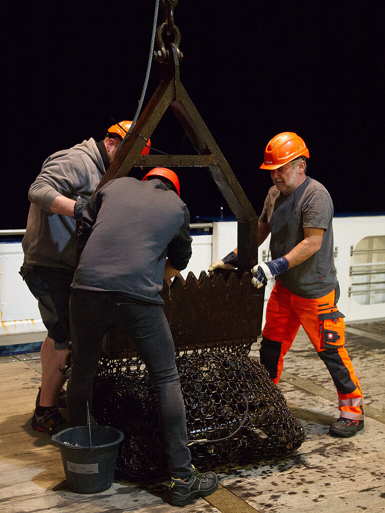 A dredge is used to retrieve rock samples from the seafloor.
