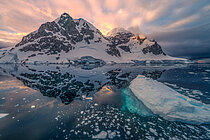 An iceberg and ice floes floating on the sea