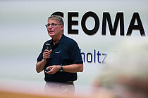 A man is giving a lecture in the lecture theatre