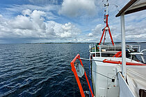 Der Bug eines Schiffes auf dem Wasser, dicht unter der Küste