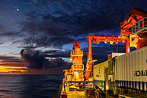 A research vessel with containers on board at sunset at sea