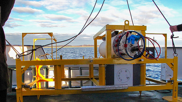 Ein gelbes Metallgestell steht an Bord eines Schiffes