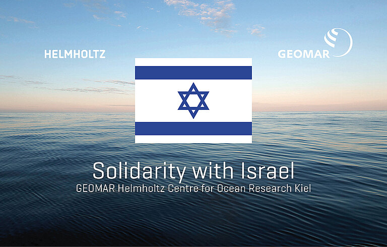 A view of the open sea in the background, in the front the flag of israel