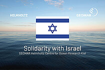 A view of the open sea in the background, in the front the flag of israel