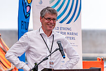 Arne Körtzinger (scientist at GEOMAR) stands behind a lectern during the UN Ocean Conference (UNOC) 2025.