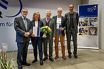 A group of four men and a women