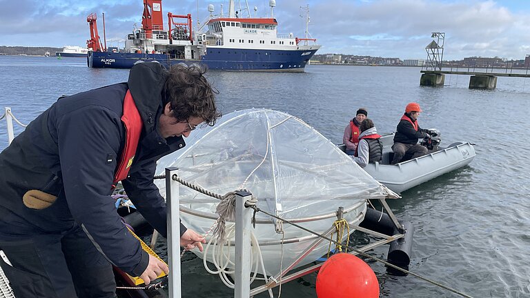The mesocosms are moored at the pier in front of the Kiel Aquarium. 