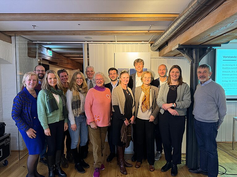 A group of people smiling into the camera