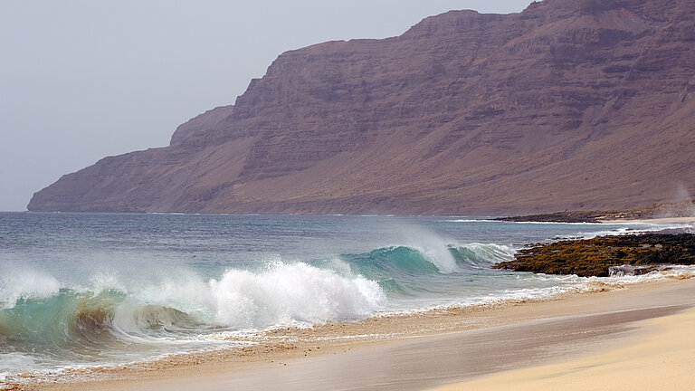 Atlantic waves roll powerfully onto a sandy beach