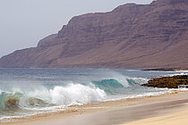 Atlantic waves roll powerfully onto a sandy beach