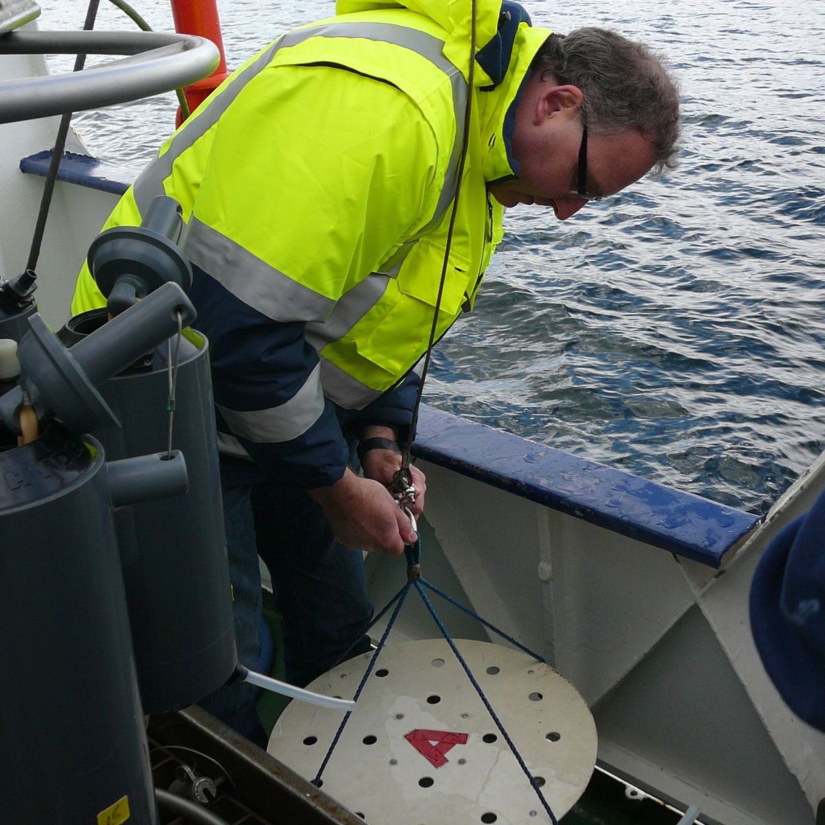 Scientist connecting ropes on instrument